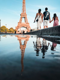 Rear view of people walking in water