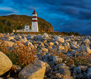 Blue hour sneaking up on golden hour at alnes lighthouse, godøy, norway