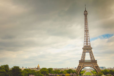 Tower of building against cloudy sky