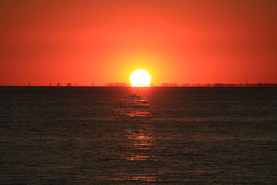 Scenic view of sea against orange sky