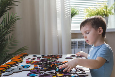 Portrait of cute girl playing with toy at home