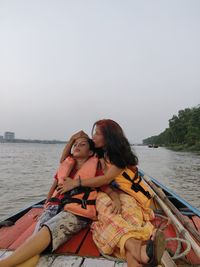 Couple kissing in lake against sky