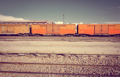 Railroad tracks by buildings against sky