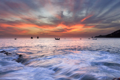 Scenic view of sea against orange sky