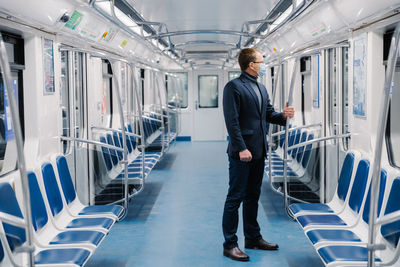Businessman standing in empty train