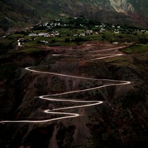 High angle view of airplane flying above land