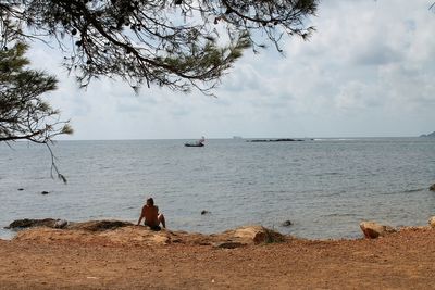 Scenic view of sea against cloudy sky