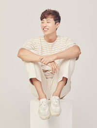 Portrait of a smiling young man against white background