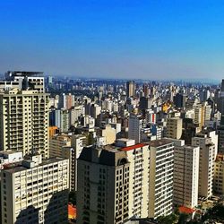 View of cityscape against blue sky