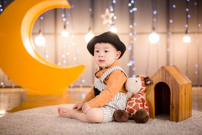 Portrait of cute boy sitting at home