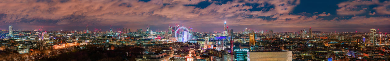 High angle view of illuminated cityscape against sky at night