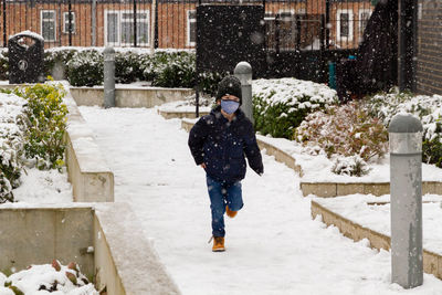 Full length of boy running on snow