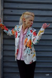 Woman standing against wall