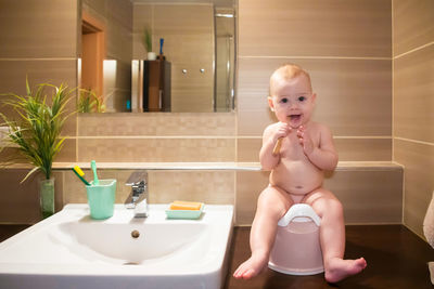 Portrait of cute baby boy in bathroom at home