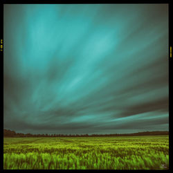 Scenic view of field against blue sky