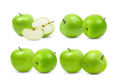 Close-up of fresh green fruits against white background