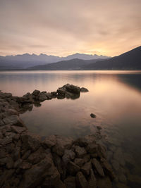 Scenic view of lake against sky during sunset