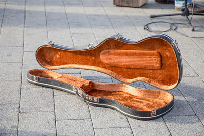 Close-up of guitar case on footpath