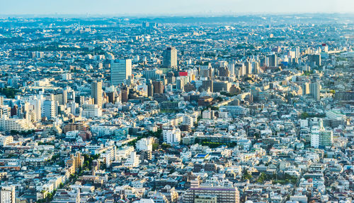 High angle view of modern buildings in city against sky