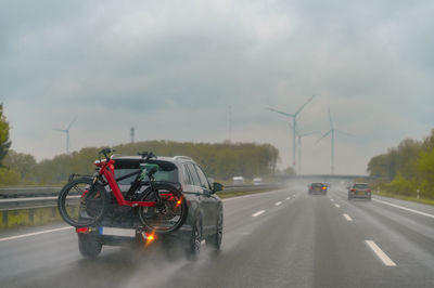 Motorway during rain, car with bike rack