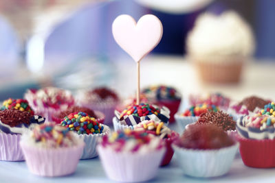 Close-up of cupcakes with heart shape on table