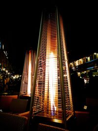Low angle view of illuminated skyscraper against sky at night