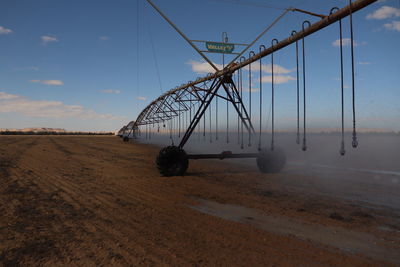 Electricity pylon on land against sky