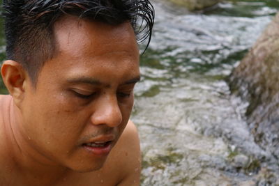 Close-up portrait of woman with water