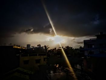 Silhouette buildings in city against sky during sunset