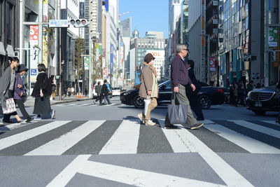 People walking on road in city