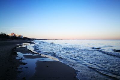 Scenic view of sea against clear sky at sunset