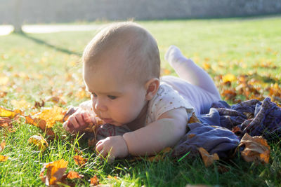 Cute girl lying on field