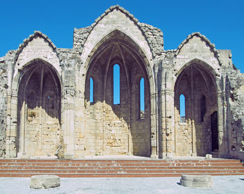 Low angle view of historical building against blue sky