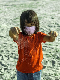Kids playing sand on the beach using mask 