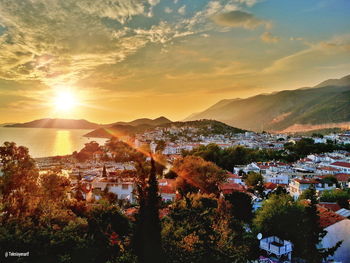 Scenic view of townscape against sky during sunset