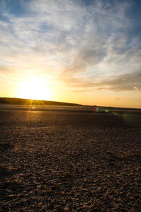Scenic view of field against sky during sunset