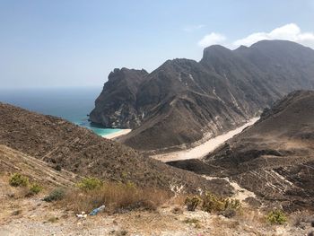 Scenic view of sea and mountains against sky