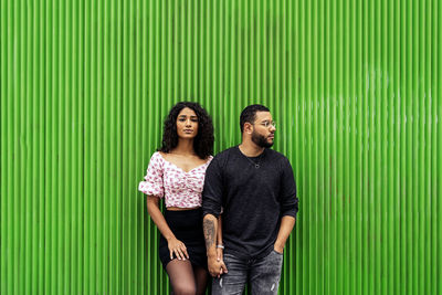 Portrait of young couple standing outdoors