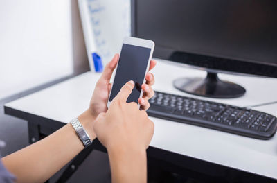 Midsection of woman using mobile phone