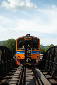 Train on railroad tracks against sky