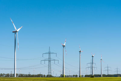 Wind energy plants and an overhead power line seen in germany