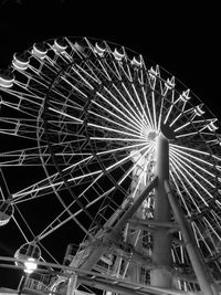 Low angle view of ferris wheel against sky at night