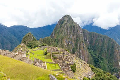 Scenic view of mountains against cloudy sky