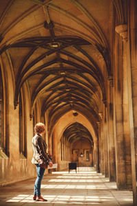 Rear view of woman standing in corridor