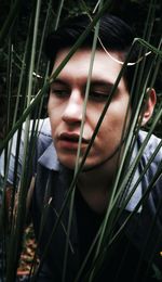 Close-up of young man by grass