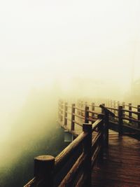 Wooden bridge in foggy weather