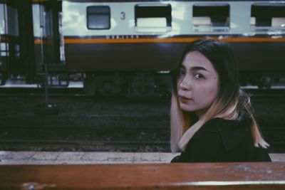 Portrait of woman on railroad track