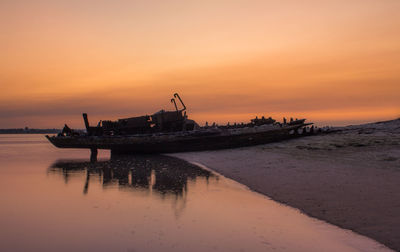 Scenic view of sea against orange sky