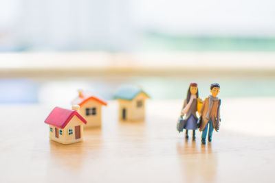 Close-up of figurines and model homes on table