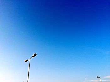 Low angle view of street light against clear blue sky